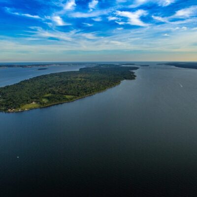 An aerial view of an island in a body of water affected by Harmful Algal Bloom.