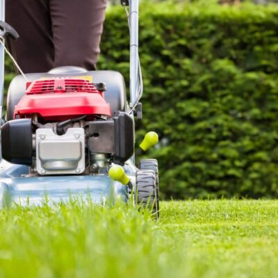 A person cutting grass with a lawn mower.