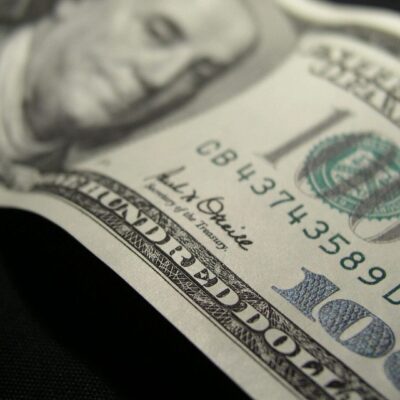 Close-up of a US hundred-dollar bill showing Benjamin Franklin.