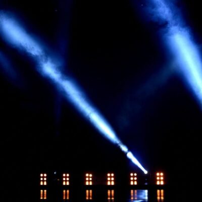 A stage with blue lights and a black background.