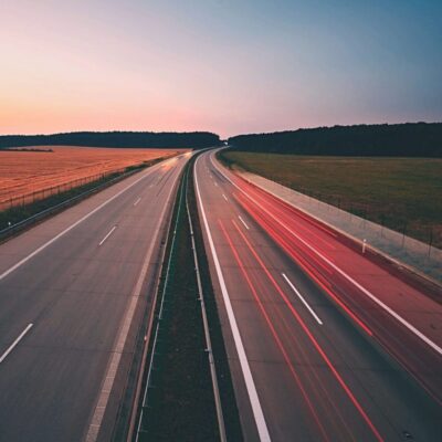 An aerial view of a highway at sunset.