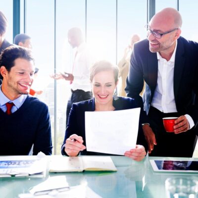 A group of business people sitting around a table.