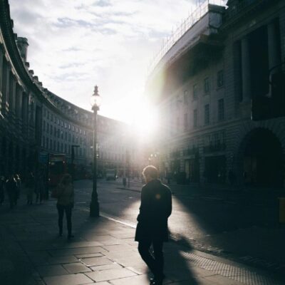 A person walking down a street in london.