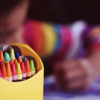 Colorful crayons in a yellow box.