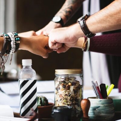 A group of people shaking hands at a table.