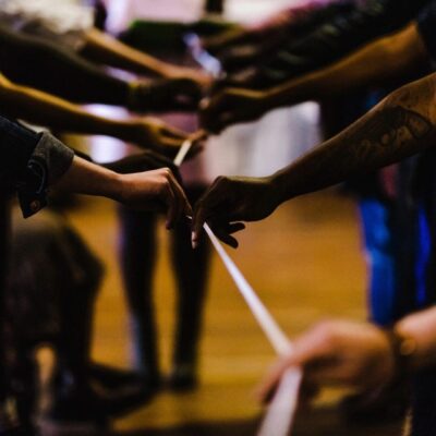 A group of people holding a rope together.