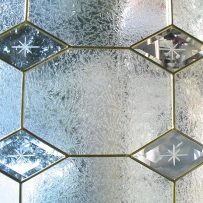 A close up of a glass window with diamonds on it.