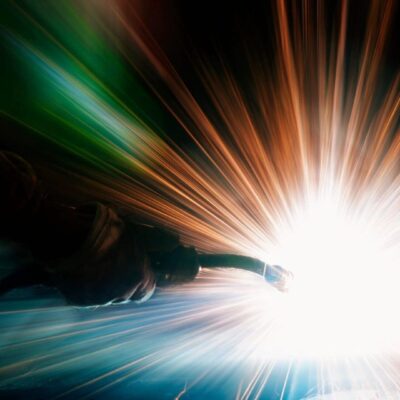 Here's an alt tag for the image: Welding sparks, bright light, metalwork.