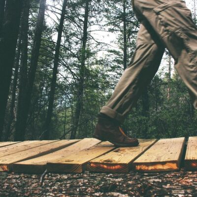 A person walking on top of a wooden path.
