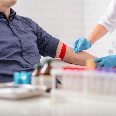 A healthcare professional drawing blood from a patient's arm.