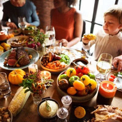 Family enjoying a festive meal with a variety of dishes on the table.