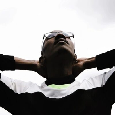 Man relaxing, head back, glasses.