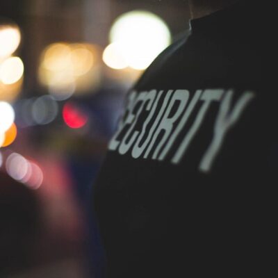 Close-up of security personnel's shoulder at night.