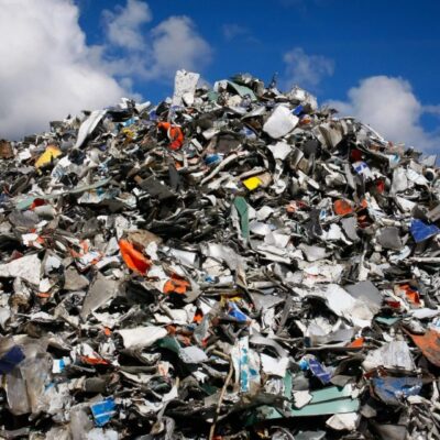 Pile of metal scraps under cloudy sky.