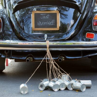 A black beetle with a sign that says 'just married'.