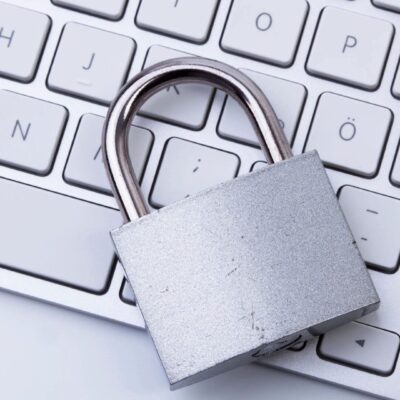 A padlock sitting on top of a keyboard.
