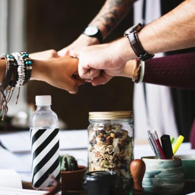 A group of people shaking hands at a table.