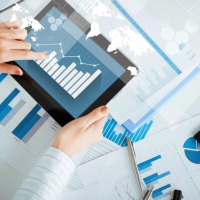Tablet displaying graphs and charts, business analysis.
