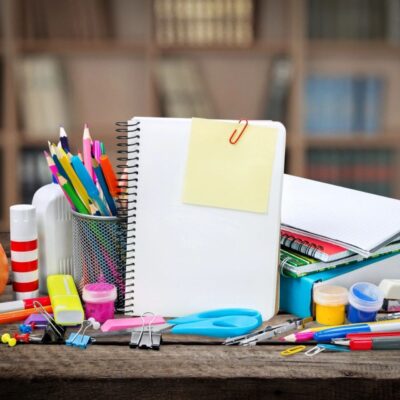 Back to school supplies on a wooden table.