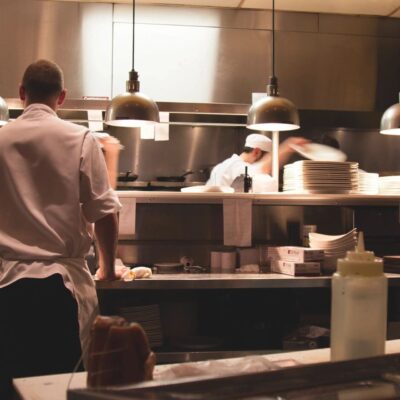 A group of people working in a restaurant kitchen.