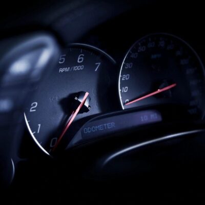 A close up of a speedometer in a car.
