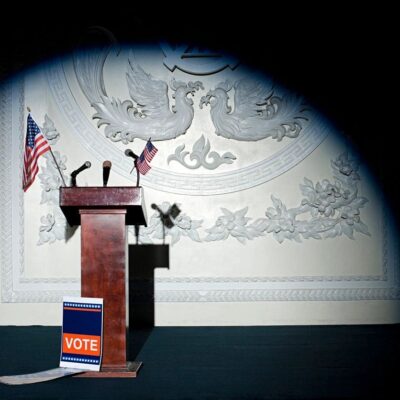 A podium with an american flag in front of it.