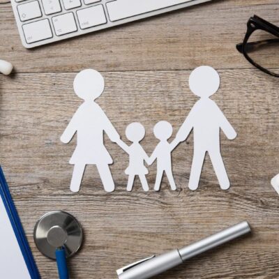 Family paper cutouts with medical items.