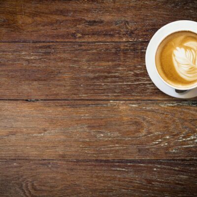 A cup of coffee on a wooden table.