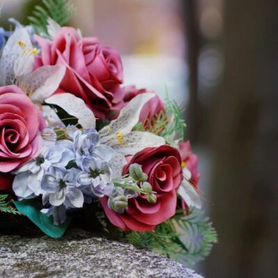 A bouquet of flowers on top of a stone slab.