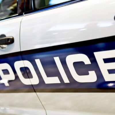 A police car is parked in a parking lot.