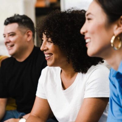 A group of people sitting together and laughing.