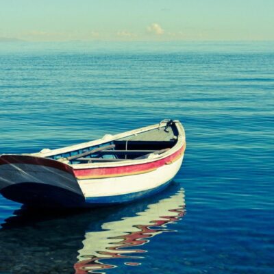 Boat floating on calm blue sea.
