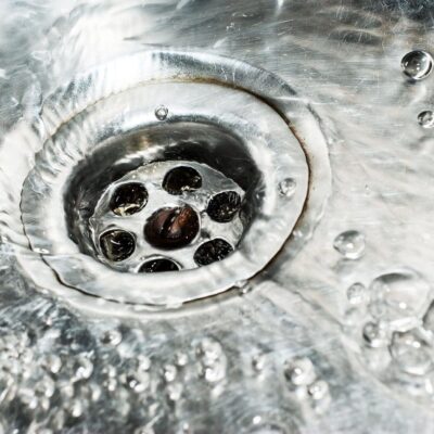 A close up of a sink with water coming out of it.