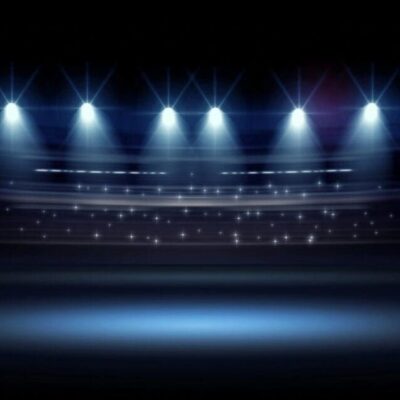 An image of a dark stage with spotlights.