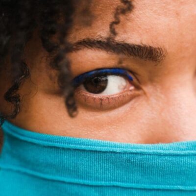 A woman wearing a blue face mask.