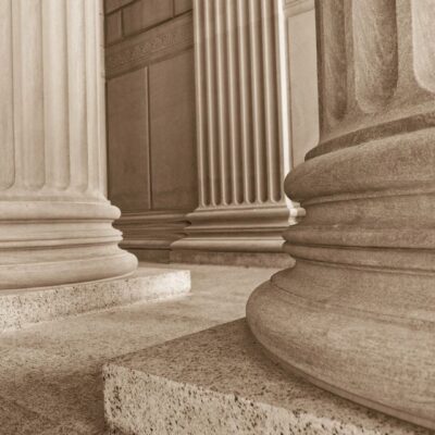 Close-up of classical stone columns with fluted shafts.