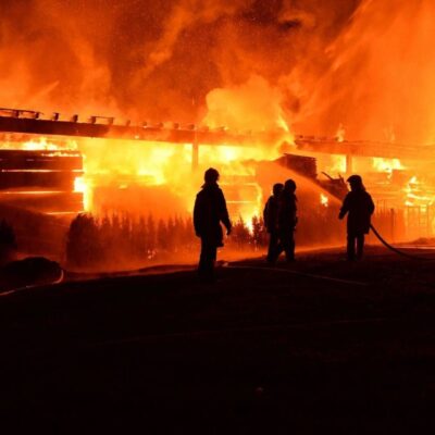 Firefighters battling large building fire.