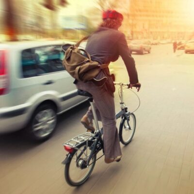 A man riding a bicycle on a city street.