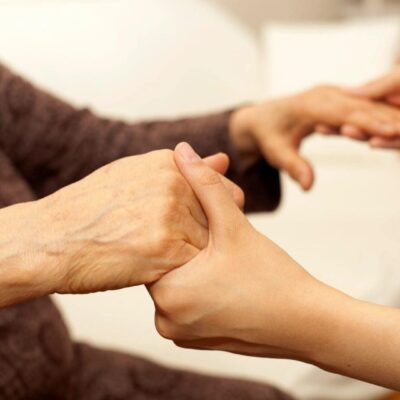 Hands gently holding each other, symbolizing care and support.