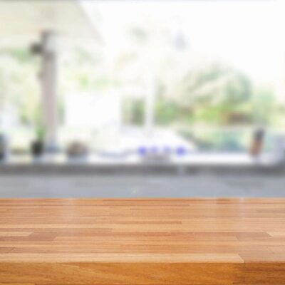 Wooden table top, blurred kitchen background.
