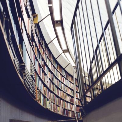 Curved library shelves with large windows letting in natural light.