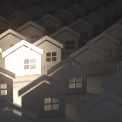 A light shining through a group of houses.