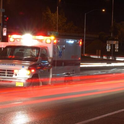 An ambulance driving down the road.