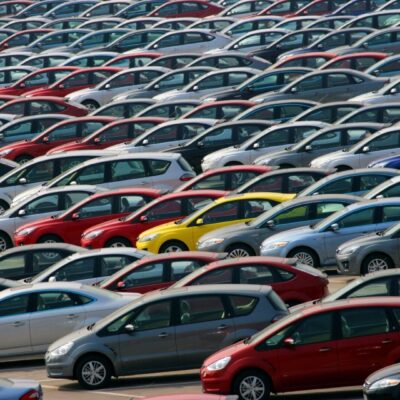 Many cars are parked in a parking lot.