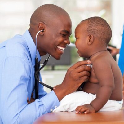 A young boy is being examined by a doctor with a stethoscope.