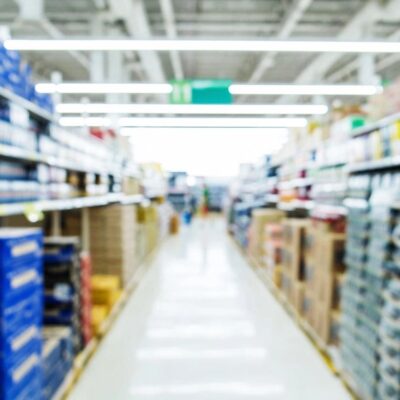 A blurry image of a aisle in a grocery store.