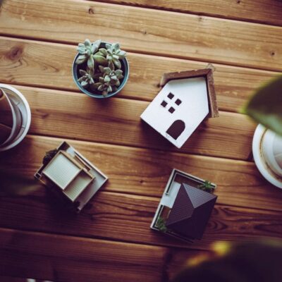 A group of house models on a wooden table.
