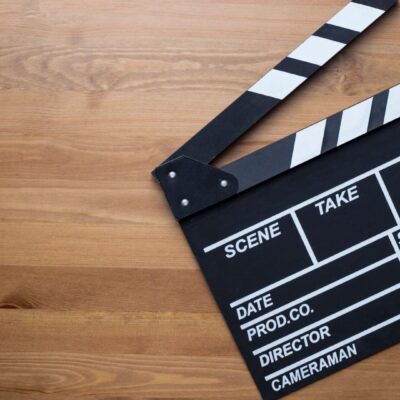 A movie clapper on a wooden table.