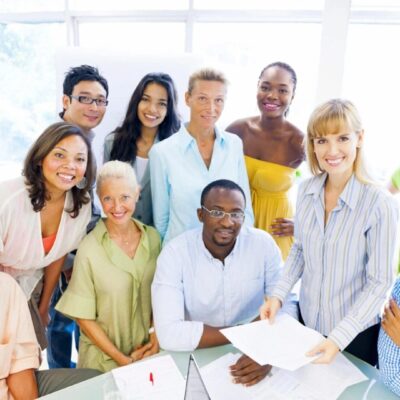 A group of people standing around a table.