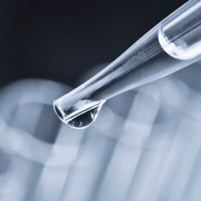 A test tube with a drop of liquid in it.